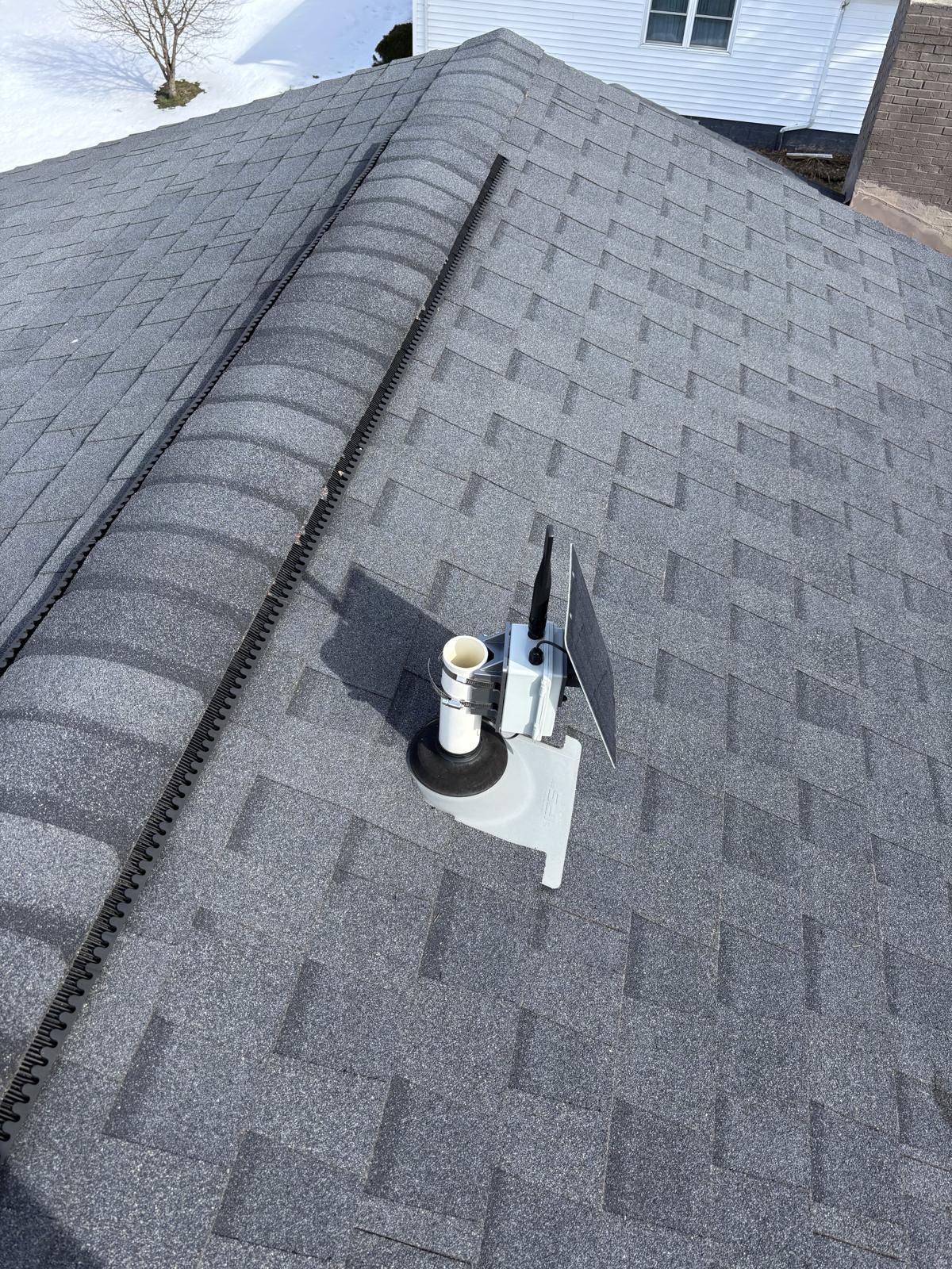 Close-up of a WNY MeshCore solar repeater installation showing the compact solar panel and weatherproof enclosure